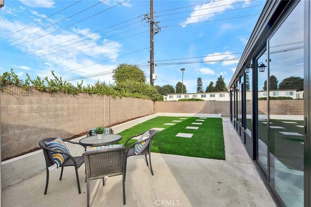 view of yard featuring a patio area and a fenced backyard