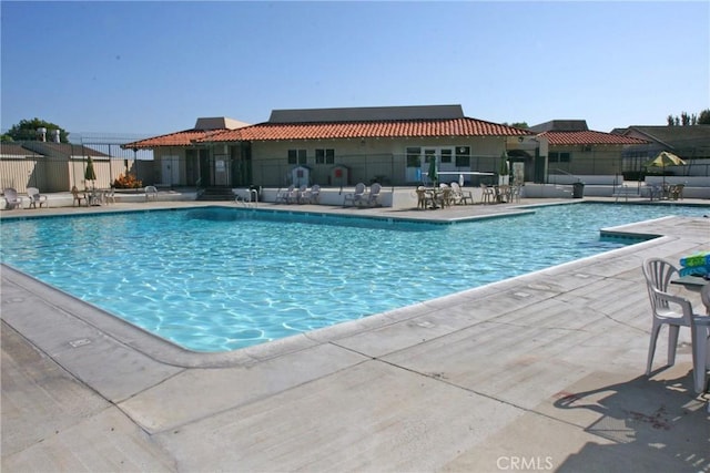 pool featuring a patio area and fence