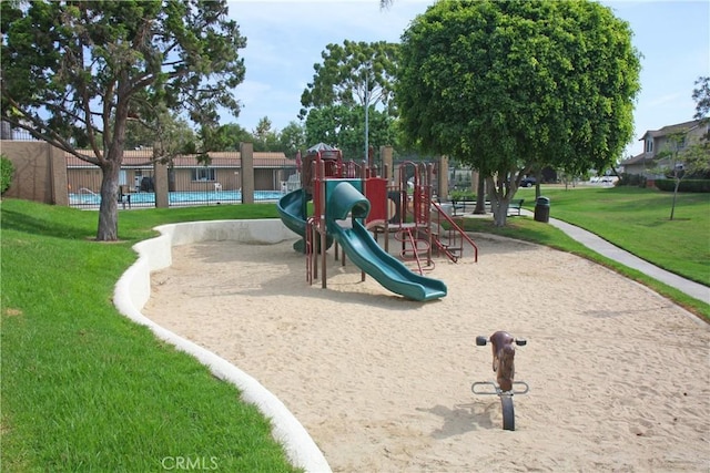 community playground with a lawn and fence