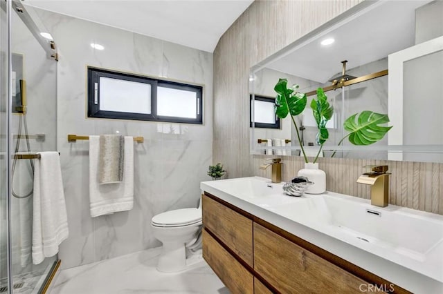 full bath with marble finish floor, a sink, and a stall shower