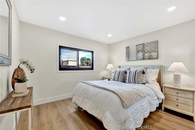 bedroom featuring light wood-type flooring, baseboards, and recessed lighting