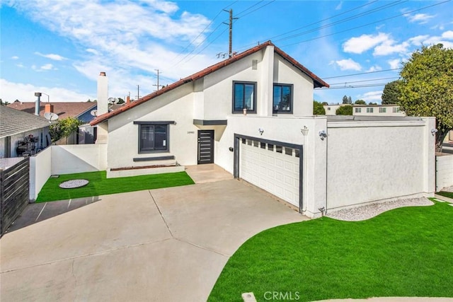 view of front of house featuring a garage, fence, driveway, stucco siding, and a front lawn