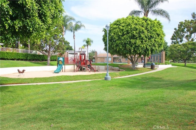 communal playground featuring a yard