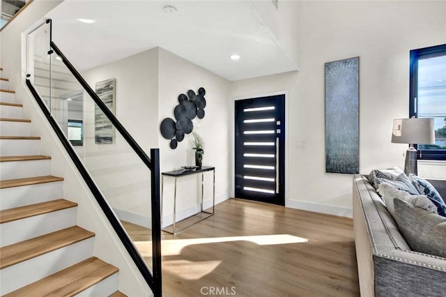 entrance foyer featuring stairway, recessed lighting, wood finished floors, and baseboards