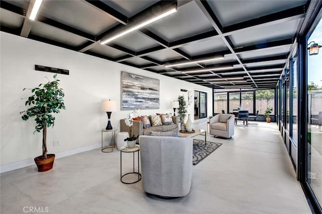 living room with a wall of windows, concrete flooring, coffered ceiling, beamed ceiling, and baseboards