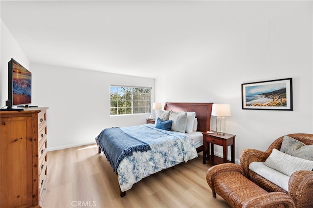 bedroom featuring light wood-type flooring and baseboards