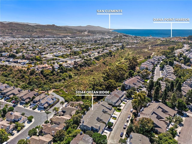 drone / aerial view with a water view and a residential view