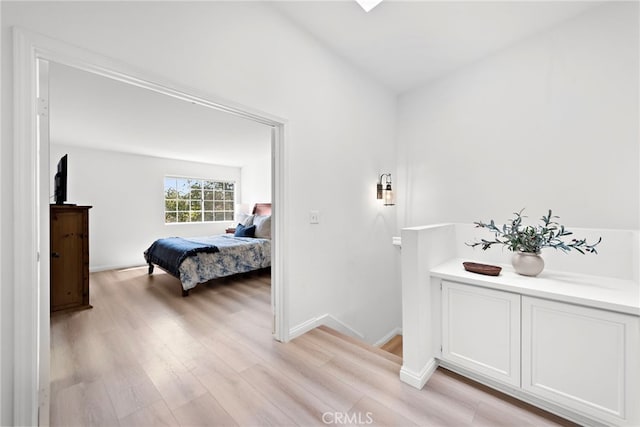 bedroom featuring light wood-type flooring and baseboards