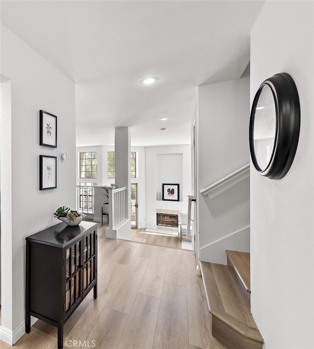 hall featuring stairway, baseboards, and wood finished floors