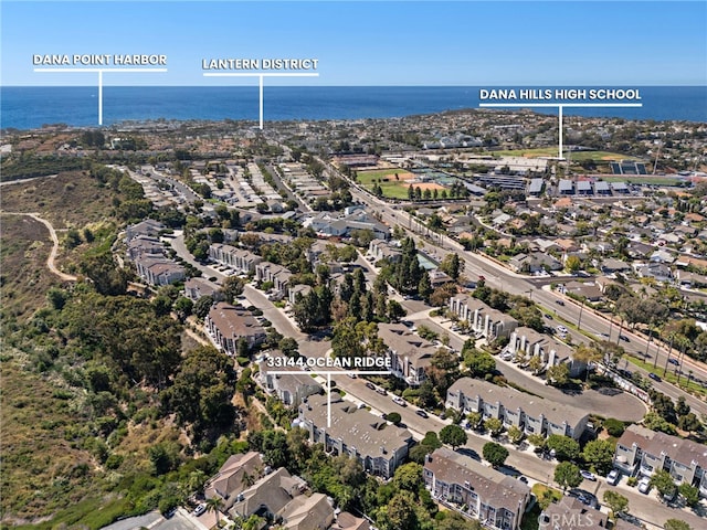 drone / aerial view featuring a residential view and a water view