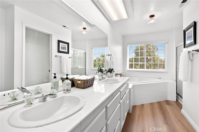 bathroom featuring a shower stall, visible vents, a sink, and wood finished floors