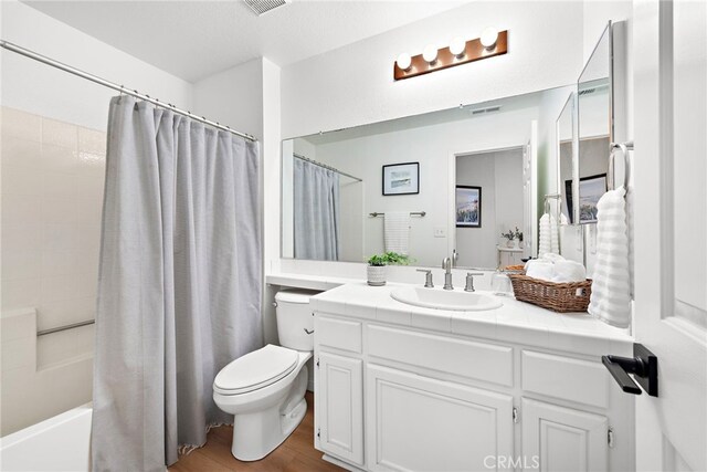 33144 Ocean Rdg, Dana Point, CA 92629 - full bath with toilet, wood finished floors, vanity, and shower / tub combo with curtain