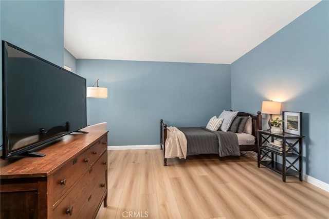 bedroom with light wood-style flooring and baseboards