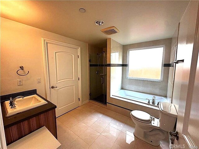 full bathroom featuring vanity, tile patterned floors, toilet, and separate shower and tub