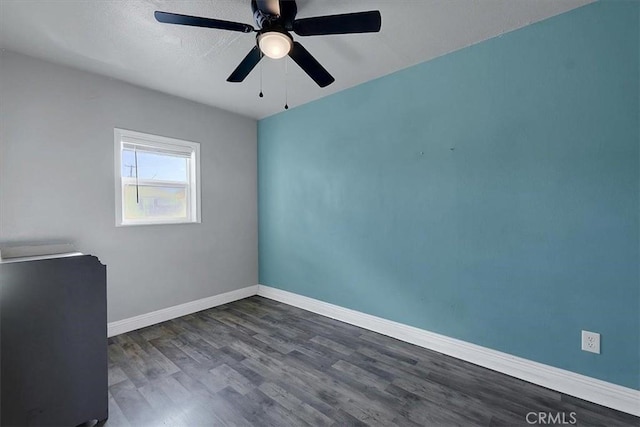 unfurnished office with dark wood-type flooring and ceiling fan