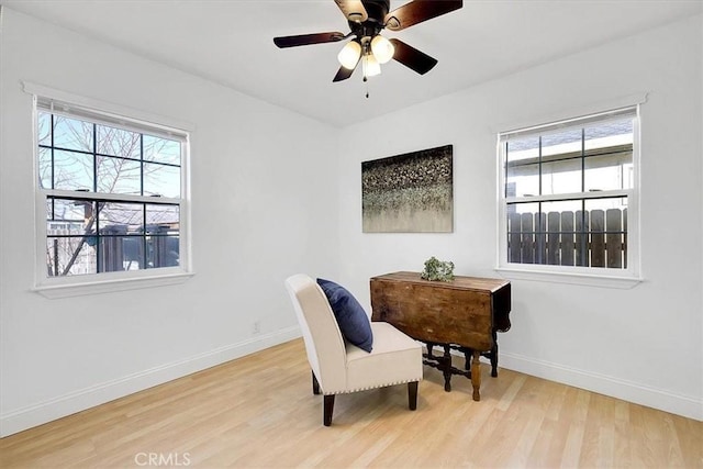 living area featuring ceiling fan and light hardwood / wood-style floors