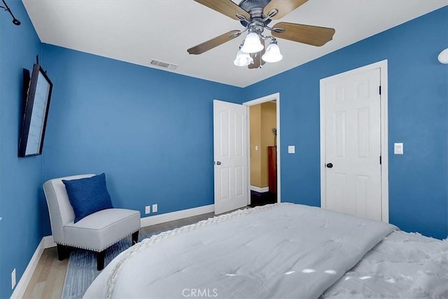 bedroom featuring wood-type flooring and ceiling fan