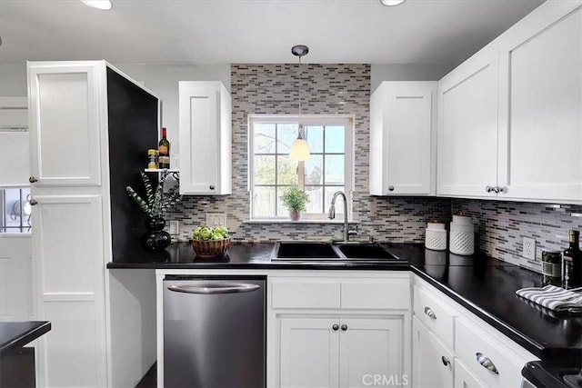 kitchen featuring white cabinetry, sink, decorative backsplash, hanging light fixtures, and stainless steel dishwasher