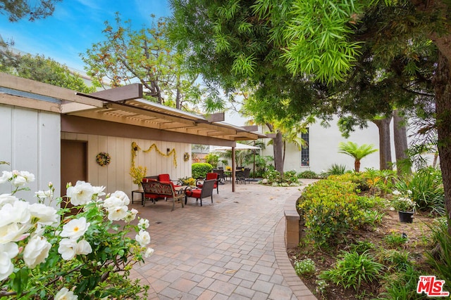 view of patio with an outdoor hangout area and a pergola