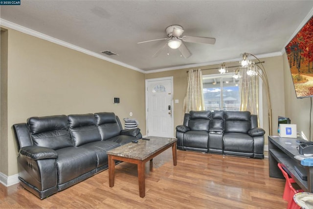 living room with hardwood / wood-style flooring, ornamental molding, and ceiling fan