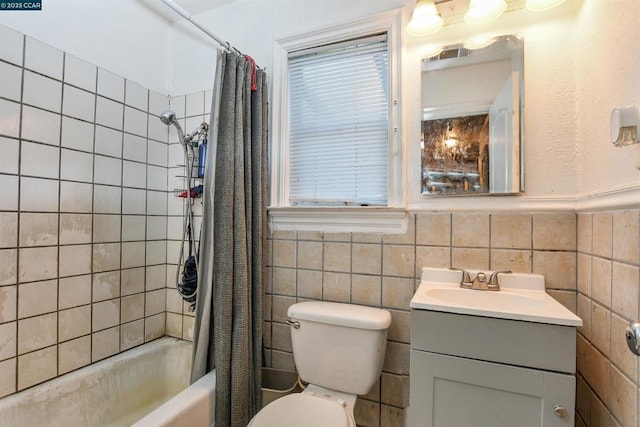 full bathroom featuring vanity, tile walls, shower / tub combo with curtain, and toilet