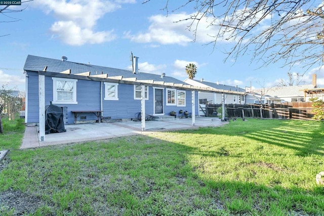 rear view of property featuring a patio and a lawn