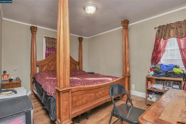 bedroom with light hardwood / wood-style flooring and ornamental molding