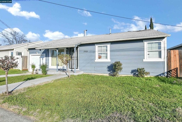 single story home featuring a garage and a front lawn