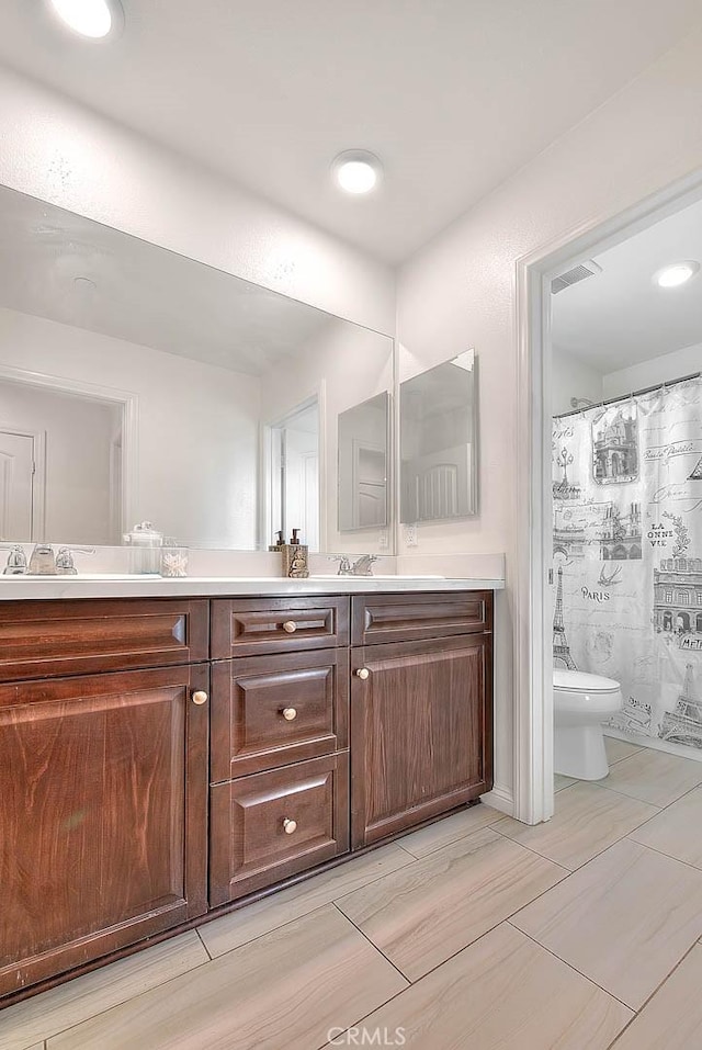 bathroom featuring vanity, a shower with curtain, and toilet