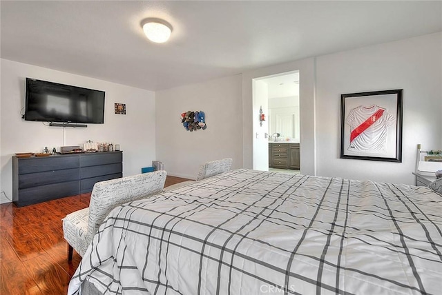 bedroom with wood-type flooring and ensuite bath