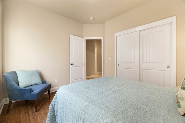 bedroom featuring hardwood / wood-style floors and a closet