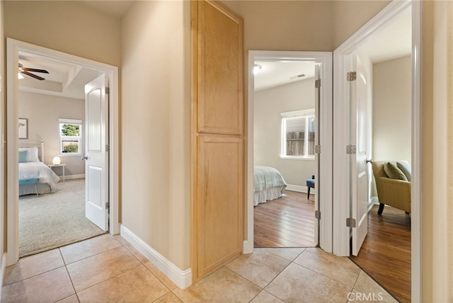 hall featuring light tile patterned flooring