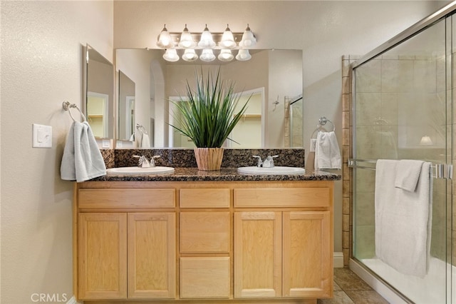 bathroom with vanity and a shower with shower door