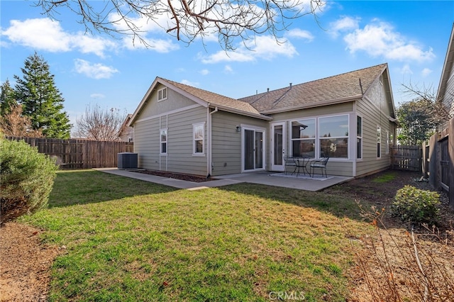 back of property with central AC, a yard, and a patio