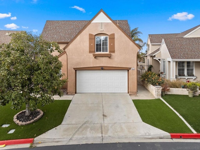 view of front of property with a garage and a front yard