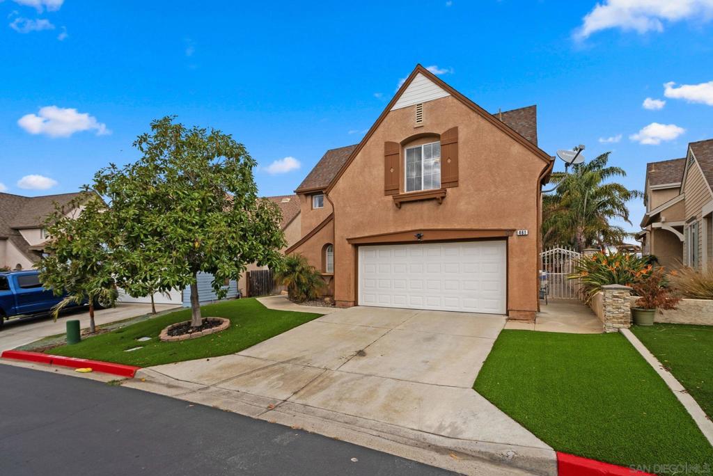 view of front of property featuring a garage and a front lawn