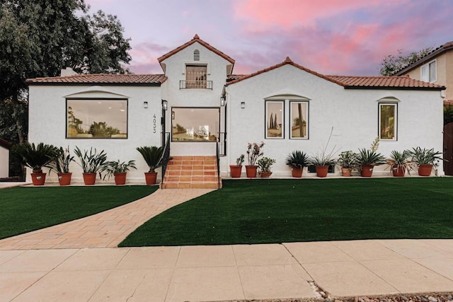 mediterranean / spanish house with a yard