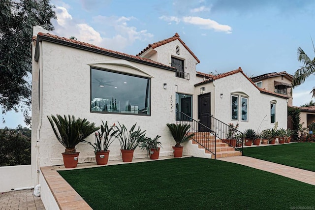 mediterranean / spanish house with a front lawn