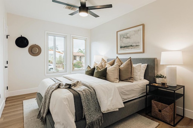 bedroom with ceiling fan and hardwood / wood-style floors