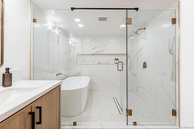 bathroom featuring vanity and shower with separate bathtub