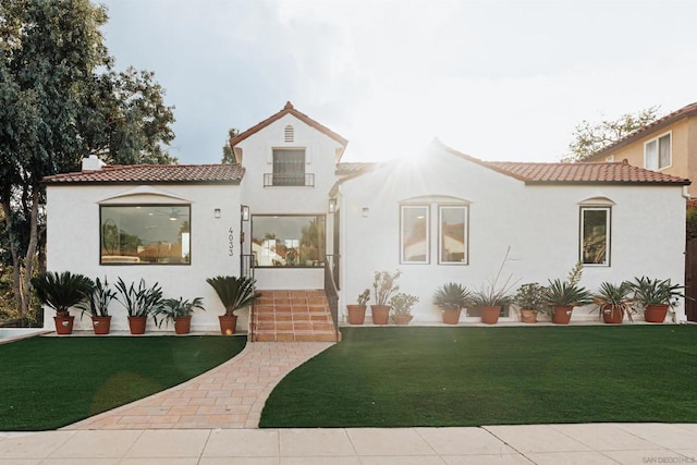 mediterranean / spanish-style home with a front yard