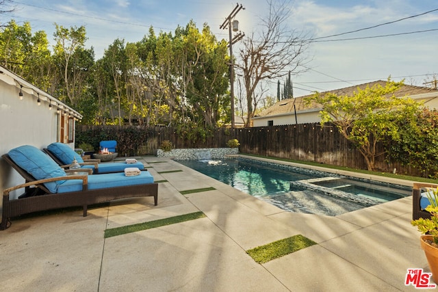 view of swimming pool featuring an in ground hot tub and a patio