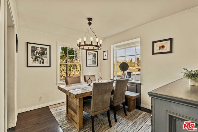 dining space featuring a healthy amount of sunlight, ornamental molding, dark wood-type flooring, and a chandelier