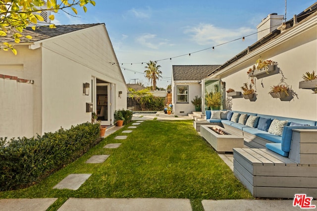 view of yard with a patio and an outdoor living space with a fire pit