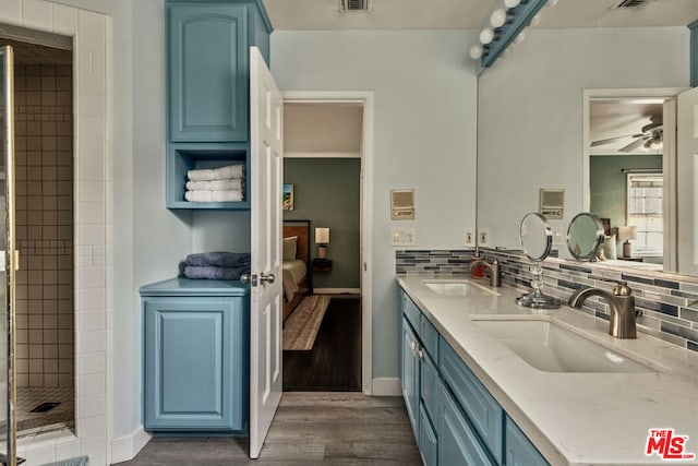 bathroom featuring ceiling fan, backsplash, tiled shower, vanity, and wood-type flooring