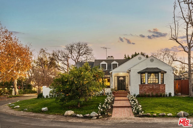 view of front of property with a yard