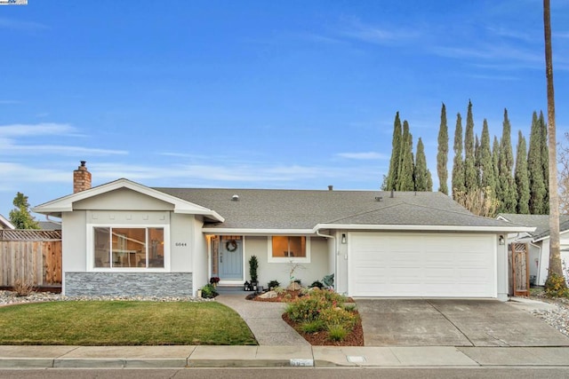 ranch-style home with a garage and a front lawn