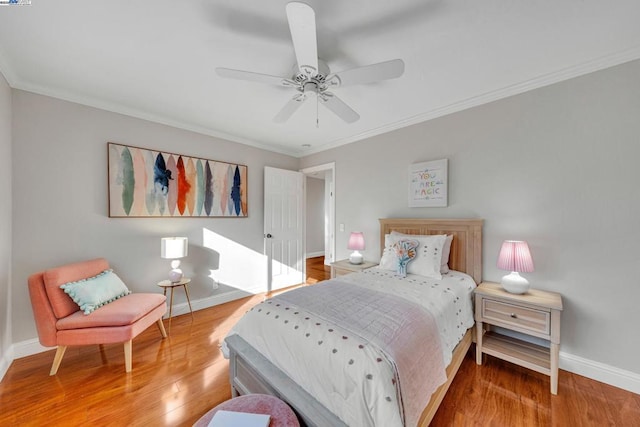 bedroom featuring crown molding, hardwood / wood-style floors, and ceiling fan