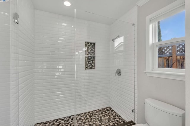 bathroom featuring toilet and an enclosed shower