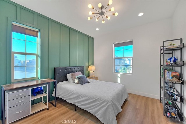 bedroom featuring a chandelier and light hardwood / wood-style floors